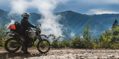 Off road motorcyclist driving through the mountains