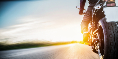 lower angle shot of a motorcycle on road riding