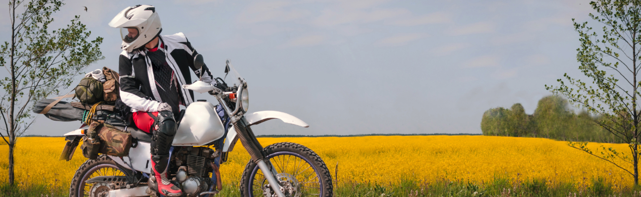 Motorcyclist looking back during scenic ride