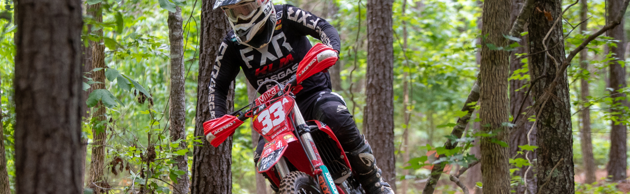 Motorcyclist driving through the forest