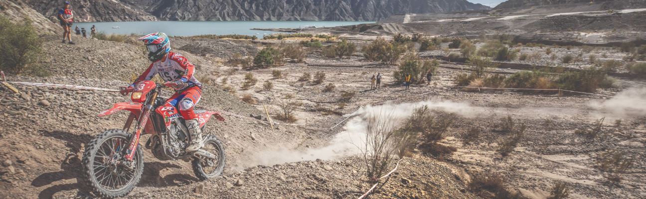 Enduro Racer driving through dusty trail